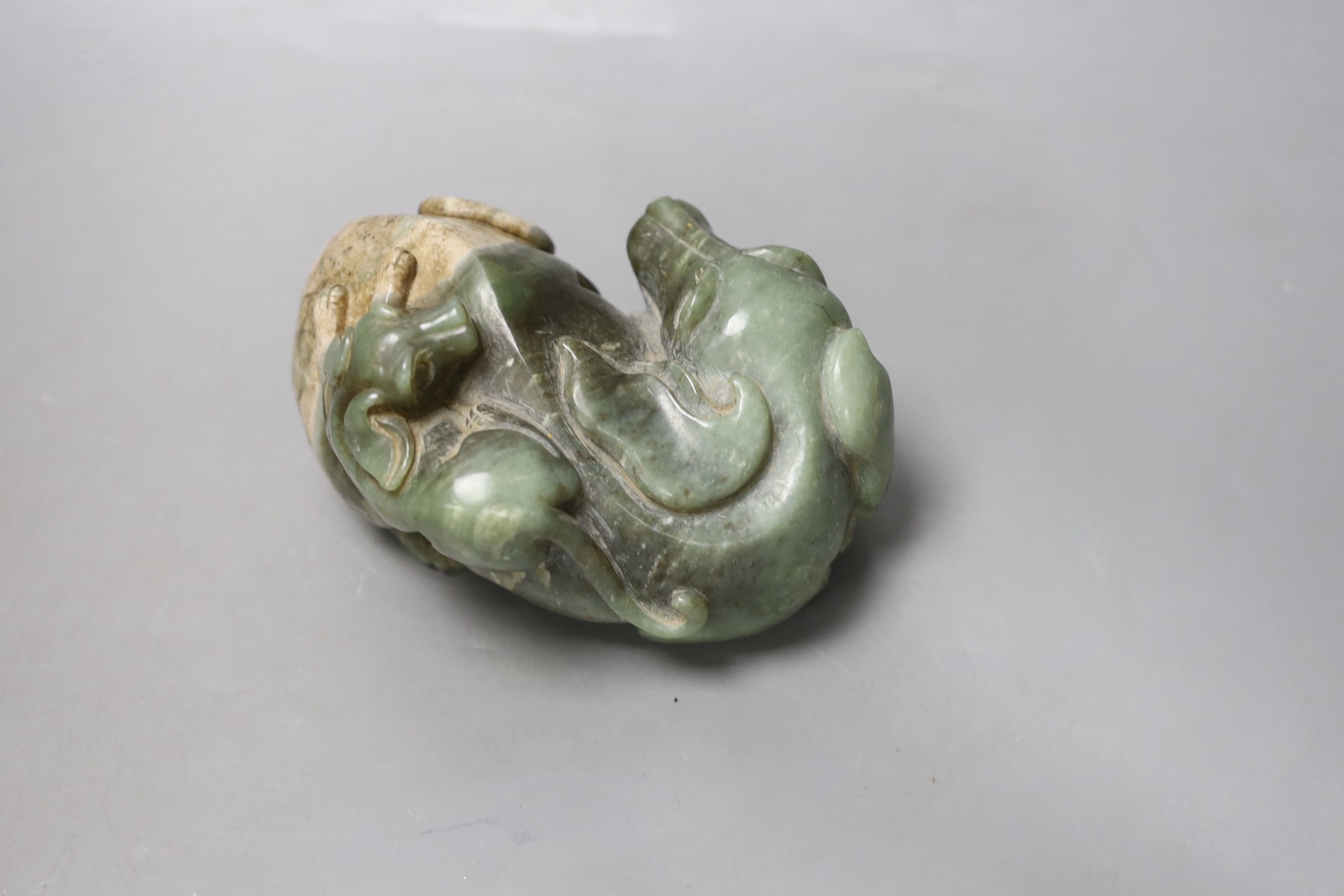 A Chinese spinach green and cream jade group of a dog and puppy, 15 cms